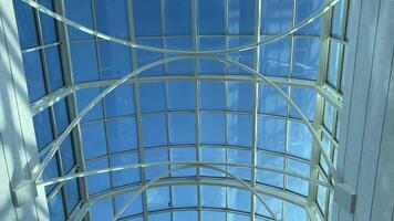 This stunning image features a magnificent glass ceiling, offering a view of the blue sky with clouds, enhancing the elegance and sophistication of any interior while creating serenity video
