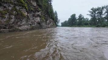 Immerse in nature with this of a river flowing through lush forests and rocky landscapes. Enjoy serene scenes of a flooded river, majestic cliffs, and vibrant trees that invite tranquility video