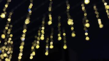 Explore the enchanting allure of golden hanging lights in stunning bokeh photography. Perfect for festive occasions, they create a cozy atmosphere that enhances any space video