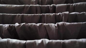 Gentle breeze moving through rows of luxurious gray curtains in elegant interior setting. video