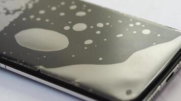 Applying screen protector on smartphone with precise hand movements. video