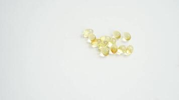 Hand placing capsules on white surface and scattered arrangement in sequence. video