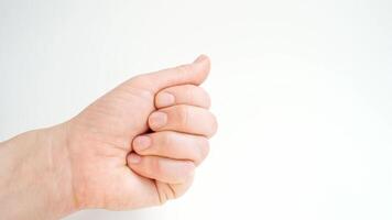 Caucasian adult hand holding and sorting yellow capsules on white background in closeup sequence. video