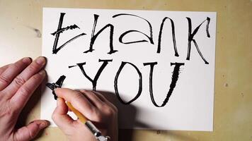 Creating handwritten thank you card with artistic brush strokes and creative design techniques. video