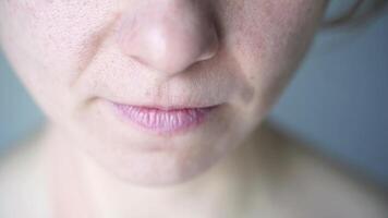 Caucasian female expresses joy through subtle smiles and a warm laugh in closeup sequence. video