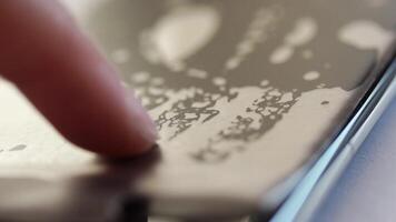 Closeup of finger interacting with smartphone screen showing dynamic touch patterns and fluid animation. video