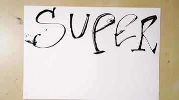 Artistic hand lettering shows transformation of super to superbad on white paper. video