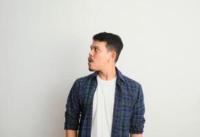 Omg. Portrait Of Surprised Asian Guy Opened Mouth In Amazement, Shocked Young Man Looking Stunned And Impressed, Emotionally Reacting To News photo