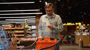 Senior citizen man looks shocked at a paper check in a grocery supermarket price increase and inflation video
