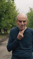 Uncomfortable Elderly Man Cannot Walk In Natural Park Under Trees video