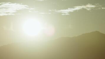 Sun Setting Behind Mountains In Silhouette Time Lapse video
