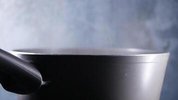 A Steaming Pot Set Against a Dark Background for Culinary Preparation video