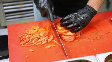 The chef is expertly slicing fresh vegetables in a modern kitchen setting video