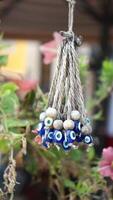 a bunch of blue evil eye keychains hanging on a shelf video
