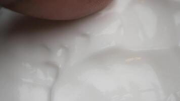 closeup of finger pick face cream from a container video