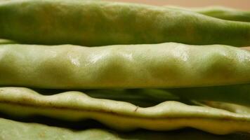 Close-up of green beans on color background video