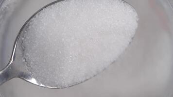 A CloseUp View of Granulated Sugar Piled on a Small Spoon for Detail video