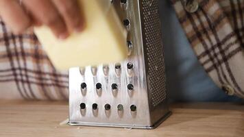Freshly Grated Cheese Being Prepared with a Grater on a Cutting Board video