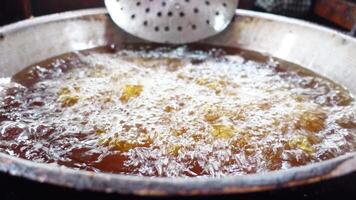 Frying up an array of delicious treats in piping hot oil for enjoyment video