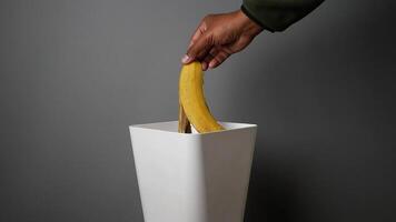 Properly Discarding Overripe Bananas into the Trash Bin to Maintain Cleanliness and Hygiene video