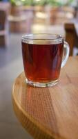 Enjoying a delicious cup of tea placed on a charming wooden table video