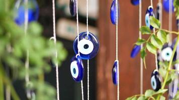 a bunch of blue evil eye keychains hanging on a shelf video