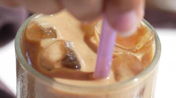Enjoy a Refreshing Iced Coffee, complete with Ice Cubes in a Clear Glass for your delight video