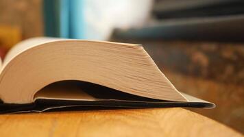 An Open Book Gracefully Resting on a Beautiful Wooden Surface video