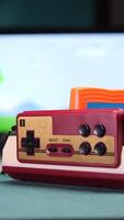 vertical Gamer inserting controller into retro game console at home video