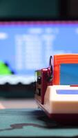 vertical Gamer inserting cartridge into retro game console at home. game over video