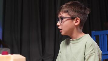 Young boy playing retro game console using a joystick at home video