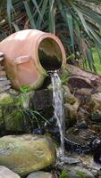 A Serene Waterfall Displaying a Clay Pot in a Beautiful Lush Garden Setting video