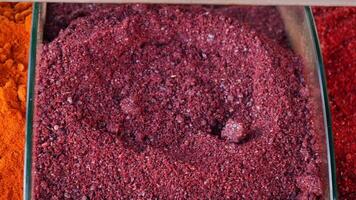 Vibrant and Colorful Red and Purple Spice Powders Located in Decorative Jars video