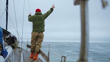 Traveling By Sea, Back View Of Man Standing On Board Of Fishing Boat In Cloudy Weather, Slow Motion video