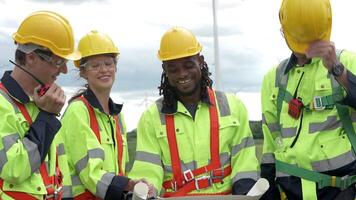The inspection of wind turbines and machinery by engineers helps drive sustainability video