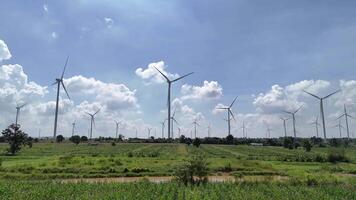 wind farm wind turbines scattered across a lush agricultural landscape, video