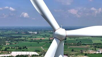 view of a wind turbine nacelle with large blades, surrounded by multiple turbines in a green landscape, emphasizing renewable energy technology, sustainability, and innovation. video