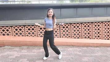 A joyful young woman da nces in harmony indoors, with large windows and a scenic view enhancing the freedom and energy. video