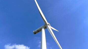 Panoramic view of large wind farm with multiple wind turbines scattered across a lush agricultural landscape, highlighting renewable energy production, sustainability, and environmental harmony. video