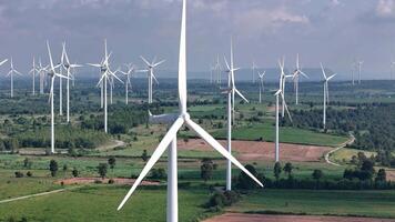 wind farm with multiple wind turbines scattered across a lush agricultural landscape, highlighting renewable energy production, video