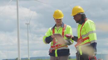 Engineers ensure the proper functioning of wind turbines as part of green energy efforts video