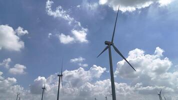 wind turbine towering above lush greenery, highlighting the role of renewable energy in reducing carbon emissions and promoting eco-friendly energy solutions for a sustainable future. video