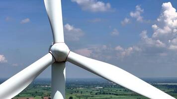 Close perspective of a wind turbine with scenic countryside views, representing innovation in clean energy, environmental responsibility, and the transition to sustainable power sources video