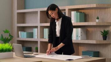Asian businesswoman girl employer architect planner designer study write on desk at office workplace chinese korean japanese business woman planning writing notes table organize manage corporate tasks video