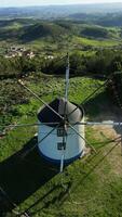 Windmill in Green Serra de Montejunto Mountains. Portugal. Aerial View. Moving Downwards, Tilt Up. Vertical video