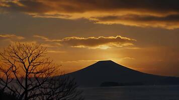 Sunset over a mountain landscape with colorful sky and clouds video