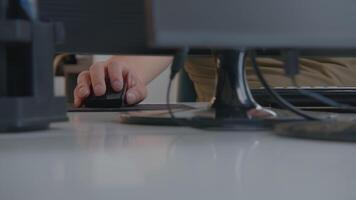 Engaged in focused work at a desk equipped with a computer, mouse, and other devices. Stock Footage video