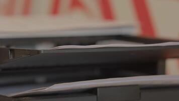 Documents Neatly Stacked on a Printer Shelf in an Organized Office Workspace Environment. Stock Footage video