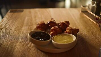 Breakfast with coffee and croissants. Small croissants with jam on a plate at cafe video