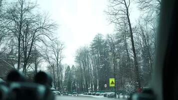 Empty winter road surrounded by towering snow banks leads towards snowy mountain. Trees and road are covered with fresh snow, which promises amazing day for powder riding in Poland Pieniny Mountains. video